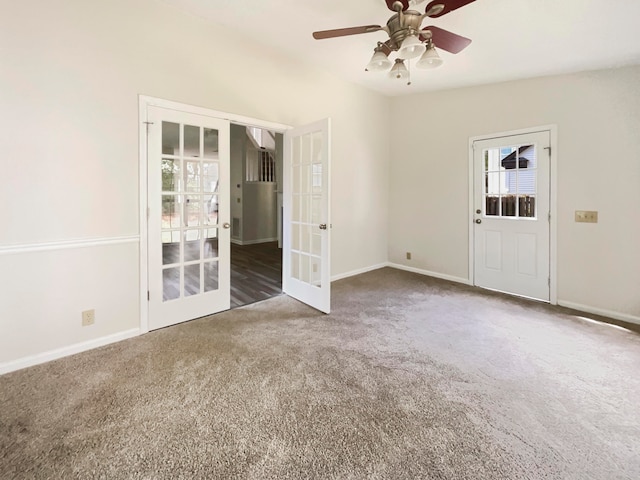 carpeted empty room with ceiling fan and french doors