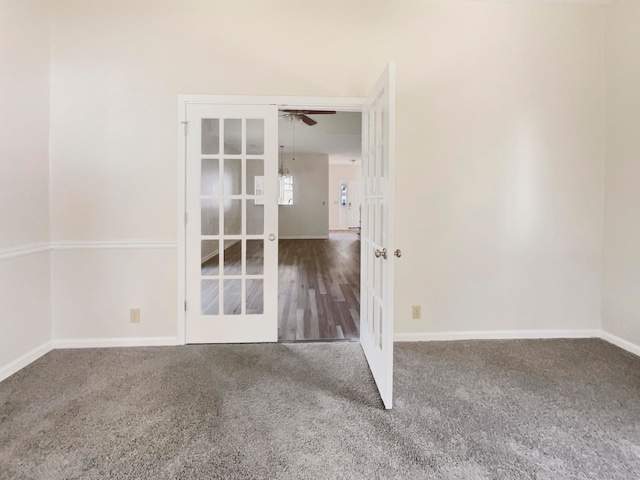 carpeted spare room featuring ceiling fan