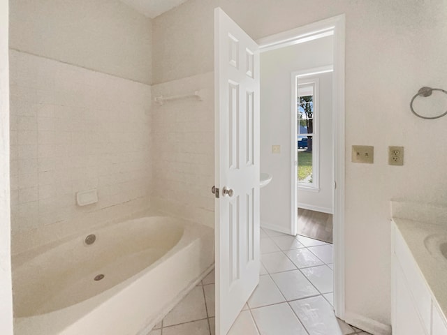 bathroom featuring tile patterned flooring, shower / tub combination, and vanity