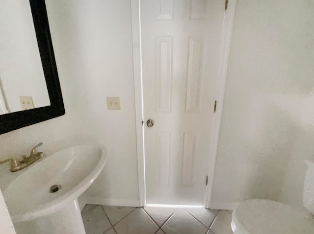 bathroom with sink, tile patterned flooring, and toilet