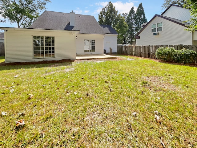 back of property featuring a lawn and a patio area