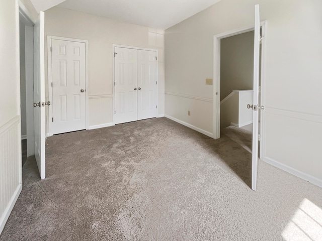 unfurnished bedroom with dark colored carpet