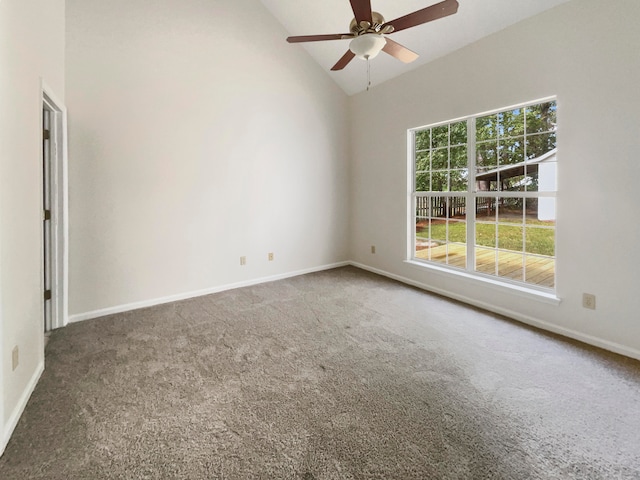 empty room featuring ceiling fan, lofted ceiling, and dark carpet