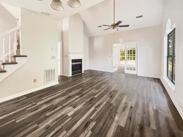 unfurnished living room featuring ceiling fan, dark hardwood / wood-style floors, and high vaulted ceiling