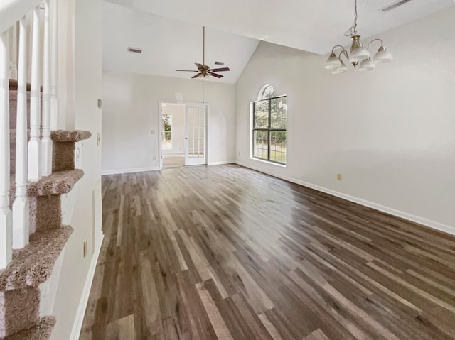 unfurnished living room featuring ceiling fan with notable chandelier, dark hardwood / wood-style flooring, and high vaulted ceiling