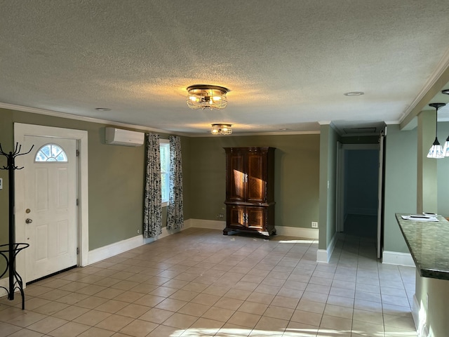 tiled foyer featuring a textured ceiling, ornamental molding, and a wall unit AC