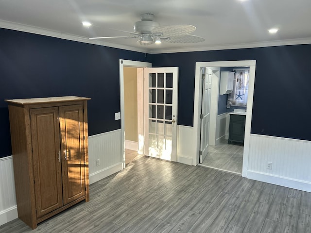 spare room featuring ceiling fan, ornamental molding, and light hardwood / wood-style floors