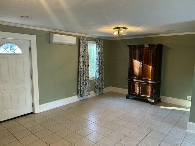 tiled foyer featuring crown molding, a wall unit AC, and a textured ceiling