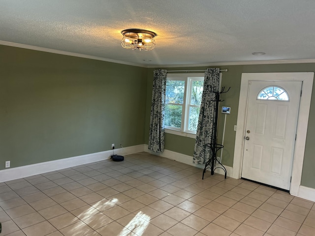 entryway with light tile patterned floors, ornamental molding, and a textured ceiling