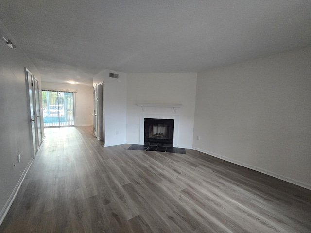 unfurnished living room featuring dark hardwood / wood-style floors and a textured ceiling