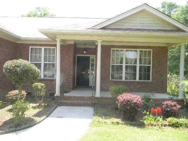 view of exterior entry with a porch