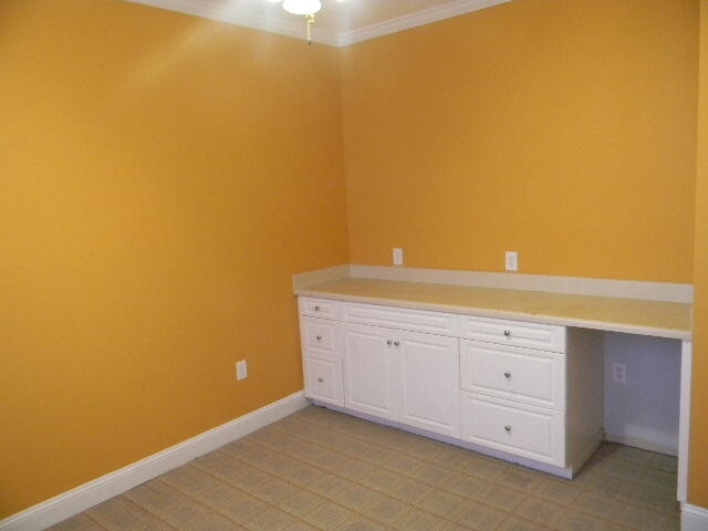 unfurnished office with crown molding