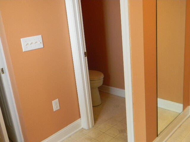 bathroom featuring tile floors and toilet