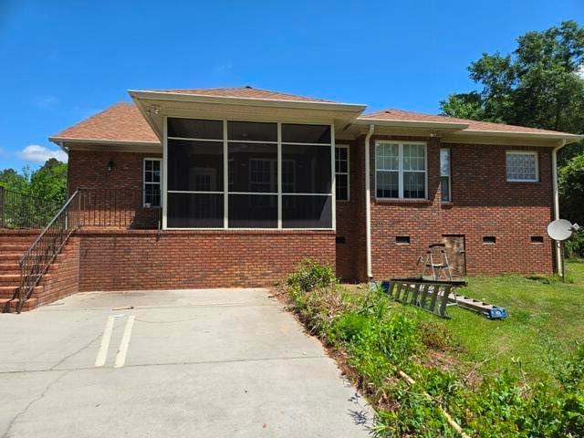 view of front of home with a sunroom