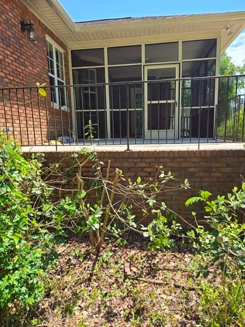 back of property featuring a sunroom