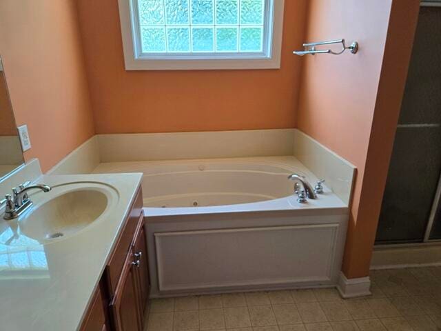 bathroom with tile floors, a bathtub, and oversized vanity