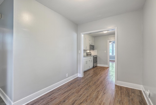 interior space with dark wood finished floors and baseboards