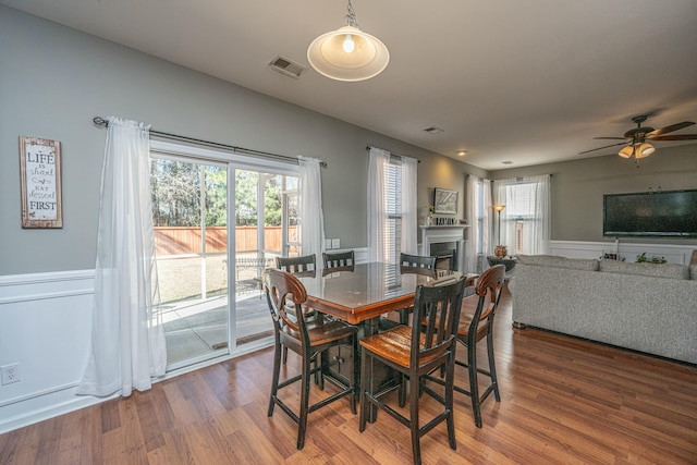 dining room with ceiling fan and wood-type flooring