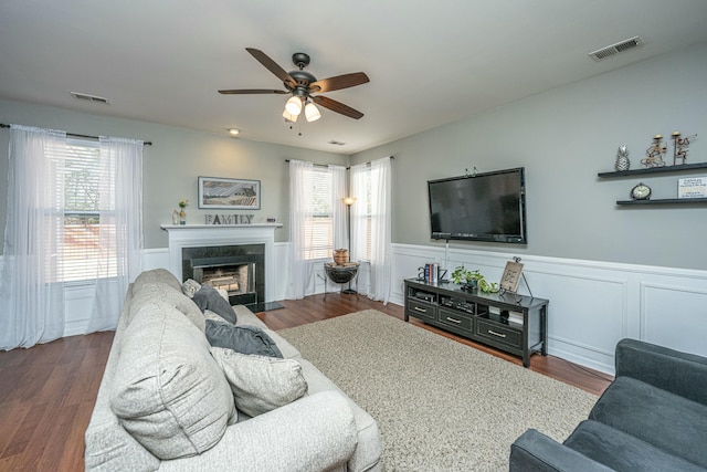 living room with ceiling fan and dark wood-type flooring