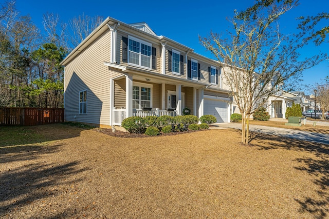 view of front of house featuring a front yard, a porch, and a garage