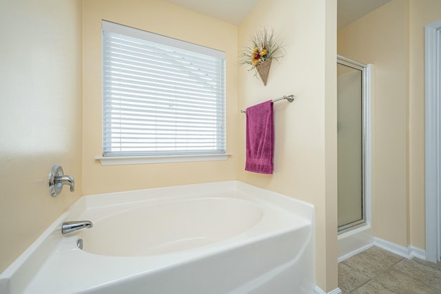 bathroom with independent shower and bath and tile patterned floors