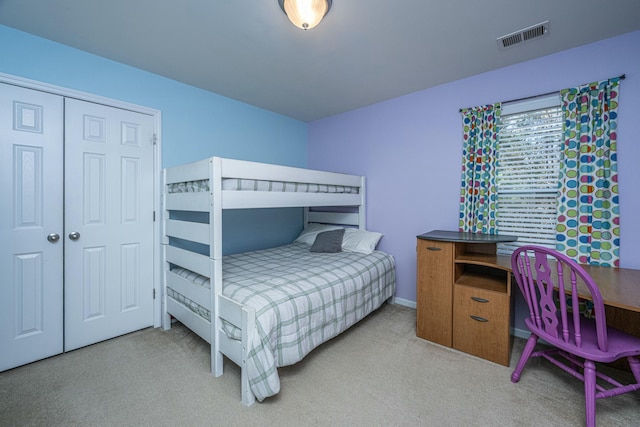 bedroom featuring light carpet and a closet