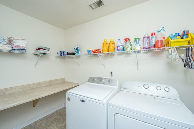 clothes washing area featuring separate washer and dryer