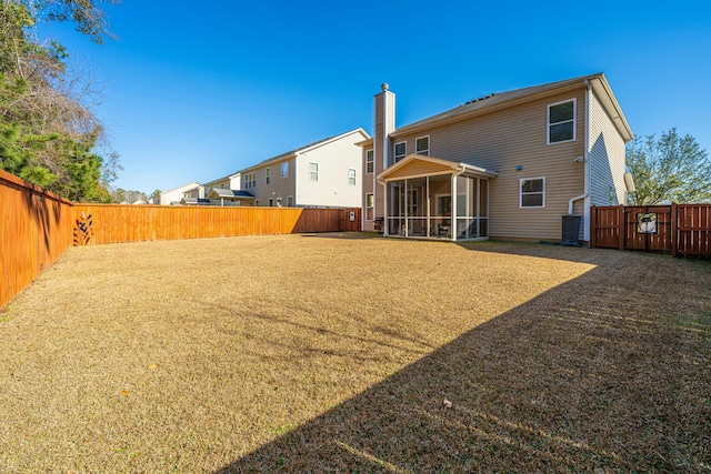 rear view of property featuring a sunroom