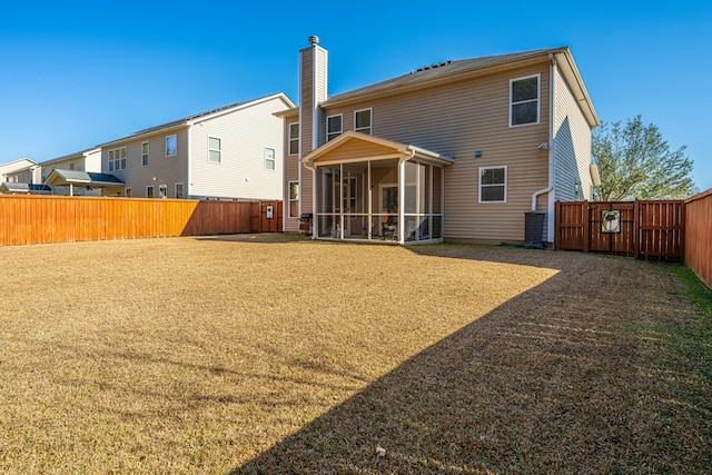 rear view of property featuring a sunroom