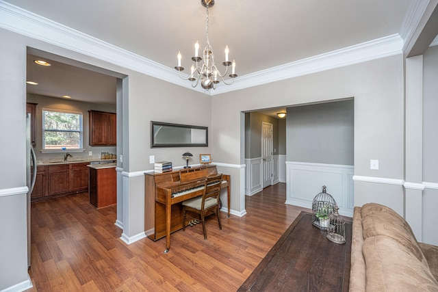 interior space featuring a chandelier, ornamental molding, dark hardwood / wood-style floors, and sink