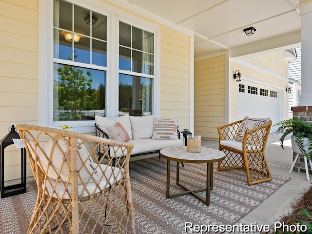 view of patio / terrace with an outdoor living space and a garage