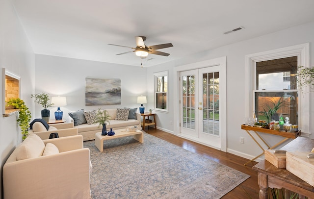 living room with ceiling fan, dark wood-type flooring, and french doors