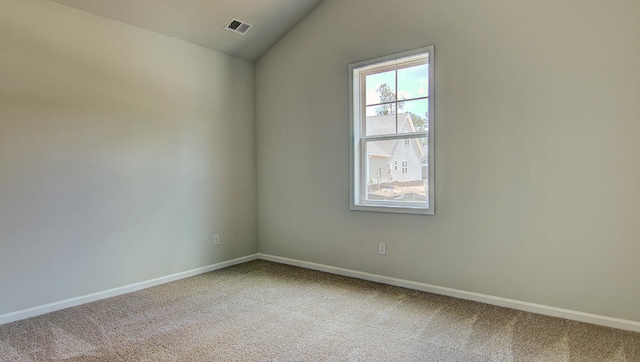 unfurnished room with carpet floors and vaulted ceiling