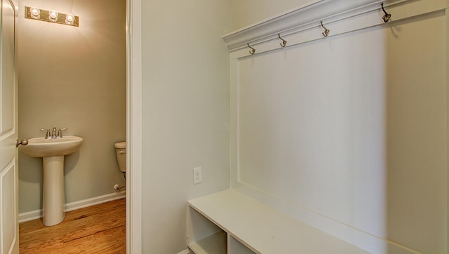 mudroom with sink and light hardwood / wood-style floors