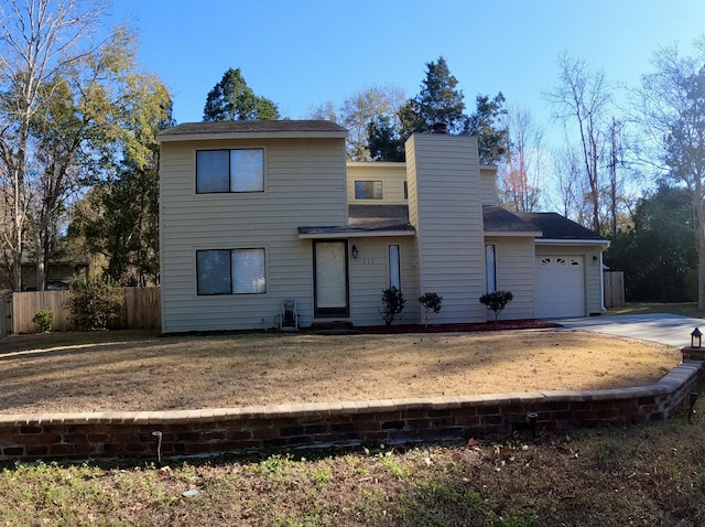 view of front of property with a front yard and a garage