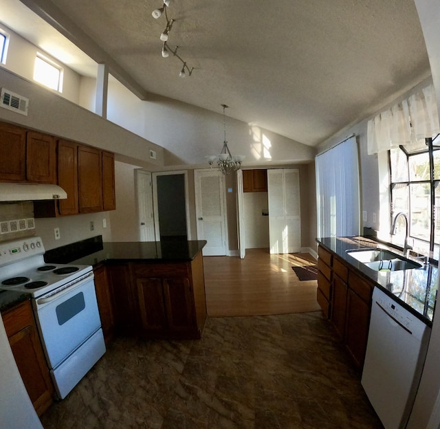 kitchen with plenty of natural light, sink, white appliances, and an inviting chandelier