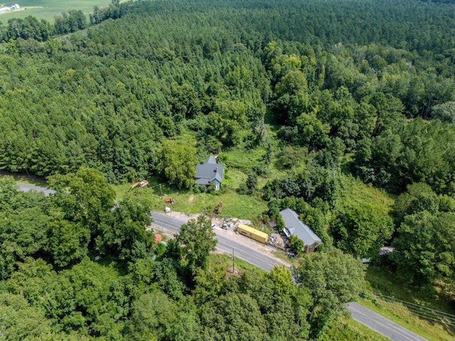 drone / aerial view with a wooded view