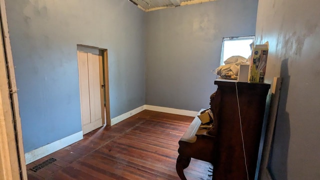 interior space featuring visible vents, baseboards, and hardwood / wood-style flooring