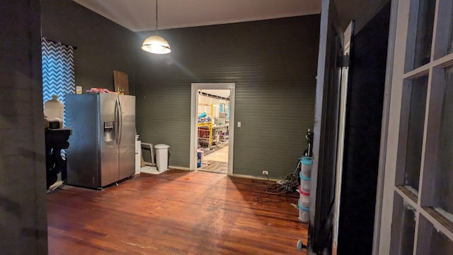 kitchen with stainless steel refrigerator with ice dispenser and wood finished floors