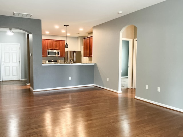 115 Hyrne Dr, Goose Creek, SC 29445 - kitchen with stainless steel appliances, arched walkways, dark wood finished floors, and baseboards