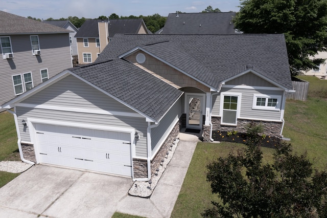 115 Hyrne Dr, Goose Creek, SC 29445 - view of front of home featuring stone siding, a garage, a shingled roof, concrete driveway, and a front lawn