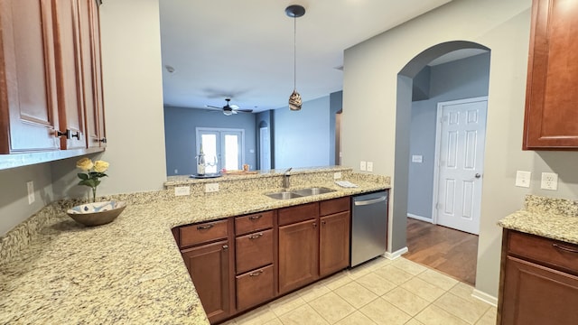 115 Hyrne Dr, Goose Creek, SC 29445 - kitchen with stainless steel dishwasher, a sink, pendant lighting, arched walkways, and light tile patterned flooring