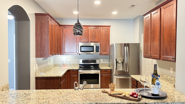 115 Hyrne Dr, Goose Creek, SC 29445 - kitchen featuring stainless steel appliances, light stone counters, recessed lighting, hanging light fixtures, and arched walkways