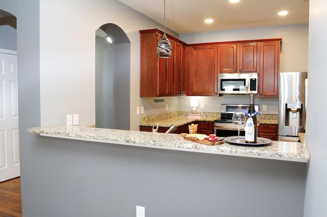 115 Hyrne Dr, Goose Creek, SC 29445 - kitchen with stainless steel appliances, arched walkways, recessed lighting, light stone counters, and a peninsula