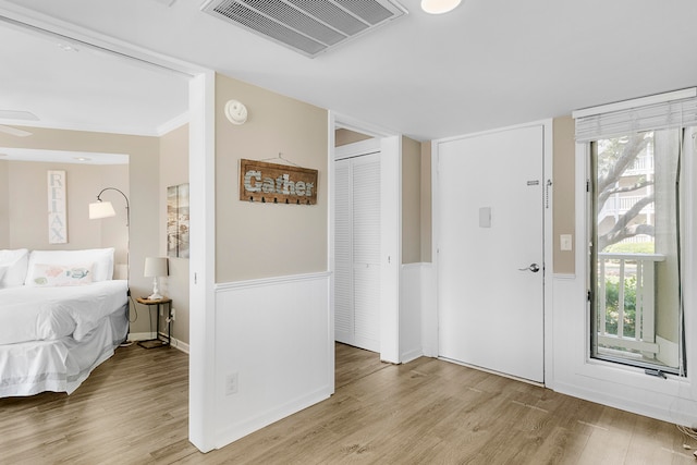 entryway with hardwood / wood-style floors, ceiling fan, and a wealth of natural light