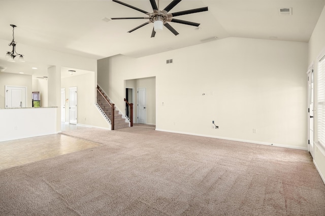 unfurnished living room featuring lofted ceiling, carpet, visible vents, and stairway