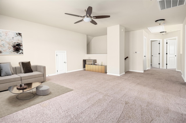 living area with baseboards, visible vents, ceiling fan, and carpet flooring