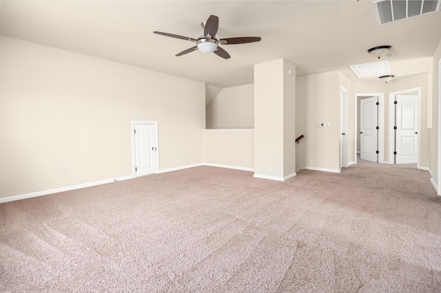 empty room featuring attic access, visible vents, carpet floors, and baseboards