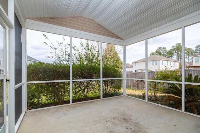 unfurnished sunroom featuring lofted ceiling