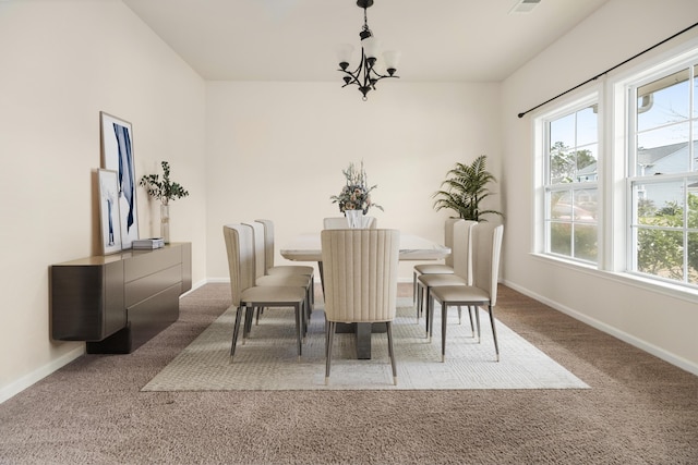 carpeted dining room with baseboards, visible vents, and a notable chandelier